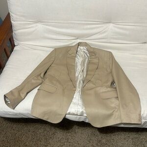 Its color is beige and about 40 in the chest nice material.